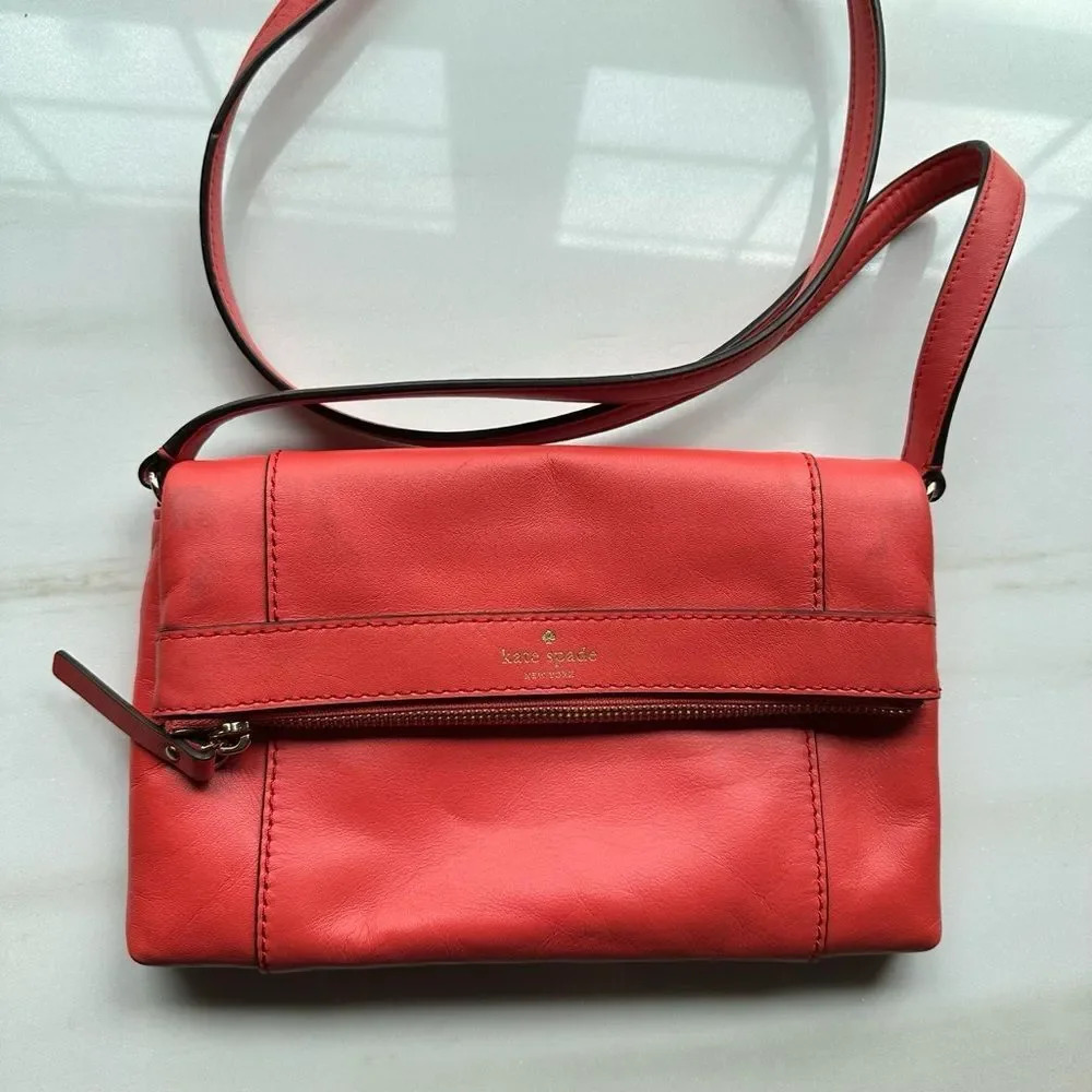 Kate Spade NWOT bright red leather but flawed from color transfer